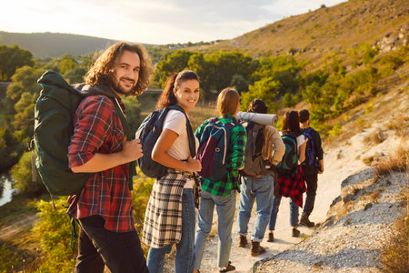 Hiking team. Group of travelers and friends traveling together in mountains and enjoying view of...