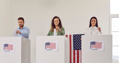 Portrait of American citizens standing in a row at polling station and putting their ballots paper...