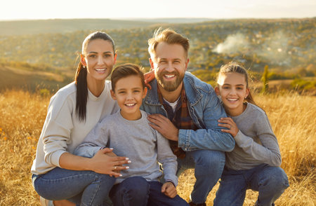 Happy family together portrait, beautiful nature background. Parents and kids sitting close, show...