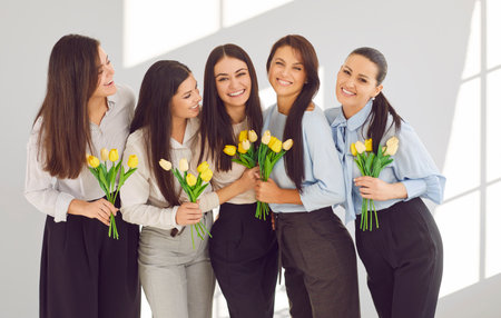 Group of happy business women in office celebrating International Womens Day together. Portrait of...