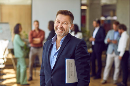 Portrait of a mature joyful smiling happy business man wearing suit looking cheerful at the camera...