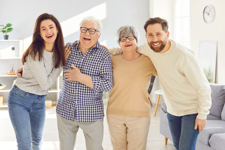 Portrait of happy, cheerful, smiling senior and young family members. Joyful old parents and adult...