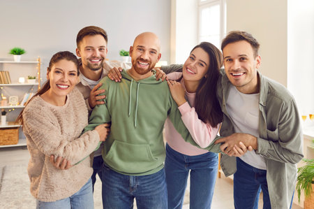 Group of happy smiling funny friends students or colleagues in casual clothes standing together,...