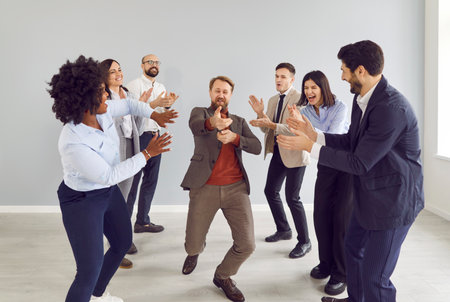 Happy excited business people group men and women having fun in office happy to make a good deal....