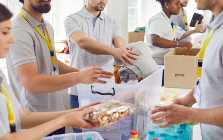 Volunteers working at humanitarian aid center. Diverse Caucasian and African American men and women...