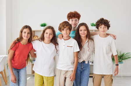 Joyful group portrait of positive crowd of kids and children at home environment. The diverse team of students, including teenagers, is happily gathered, representing unity and friendship.の写真素材