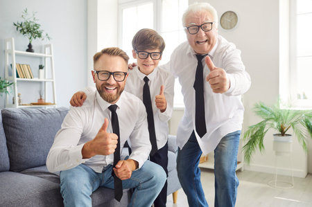 Portrait of a happy father, son, and grandfather give a thumbs up at home on Father Day. Enjoy this special occasion together, smiling and sharing a moment of happiness and pride as a family.の写真素材