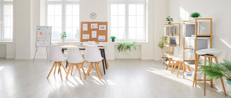 Modern design of bright spacious contemporary office with organised open space. Empty light conference room with desk, chairs and whiteboard for business meetings. Interior with no people. Banner.の写真素材