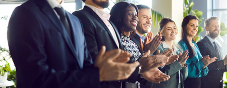 Business people applauding, supportive diverse businesspeople welcome, congratulate with job promotion or success, happy multiethnic colleagues greeting on work achievement, big team appreciationの写真素材
