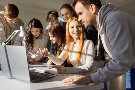 Team of young college friends students brainstorming together working online doing study project in...