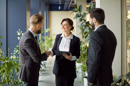 Company of corporate men and woman coworkers shaking hands during meeting, closing successful deal,...