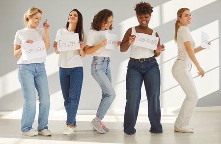 Happy girls posing holding life motivating quotes and inspiring statements, best friends advertising...