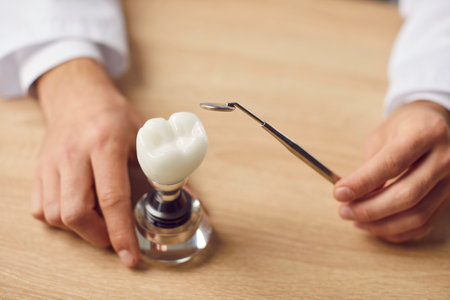 Close up shot of an orthodontist doctor hands using an dentistry instrument to examine a tooth...