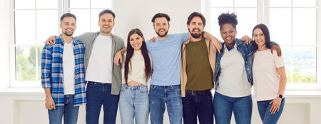 Group portrait of happy, diverse people huddled together, representing a multinational community. Crowd reflects unity and joy, highlighting their togetherness, friendship and positive relationships.の写真素材