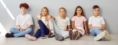 A group portrait of happy children in casual clothes. Five confident smiling kids in relaxed poses...