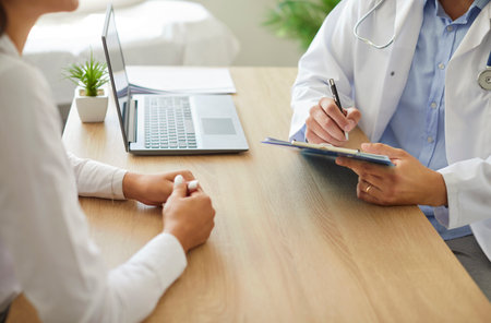 Doctor writing down patients complaints close up, visiting practitioner office, giving medical...