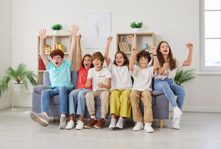 Euphoric school team cry, children group in common joy, pre-teens, teenagers diverse friends, enjoy education community club, overjoyed positive unity scream to support favorite sports team togetherの写真素材