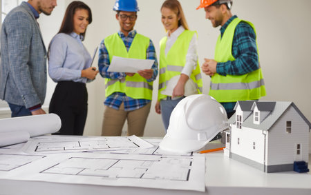 Team of diversity multiethnic architects, interior designers and workers discussing with construction blueprint property development project for housing. Engineer inspection of architectural planの写真素材