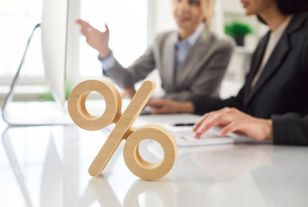Per cent sign symbol on desk, calculate percentage, precise financial results, female client, boss sitting at computer, read documents with new project or analyzing statistics, learn financial reportの写真素材