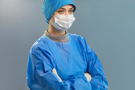 Portrait of serious woman surgeon, doctor, or nurse in hospital operation room, focusing on surgery in a professional setting with dedication and care during medical procedures daily.の写真素材