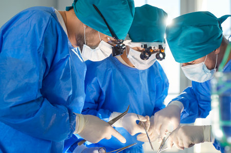 Surgeon group of professional medical doctors, surgical team performing surgery, doing operation, procedure on patient, wearing surgical gown, cap, face mask, eye loupe binocular, cutting with scalpelの写真素材