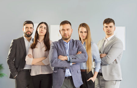 Group portrait of serious business people in team at office, showcasing diverse community with focus on work and teamwork in a professional setting with commitment and collaboration.の写真素材
