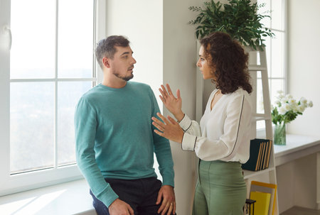 Married family couple, angry and sad, engages in arguing and quarrel at home, facing problem and conflict in a tense setting with emotional challenges.の写真素材