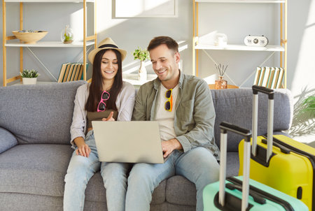 Air ticket, hotel booking service online, newlywed couple compare flight deal prices choosing tourists suitcases packed, summer beach hat, enjoying tourism, voyage, trip vacation, honeymoon planningの写真素材