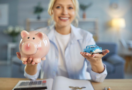 Piggy bank and toy car, happy woman planning counting to save money, motivated for result, visualize plan of buying new automobile, dream visualization, compare prices, explore financing optionsの写真素材
