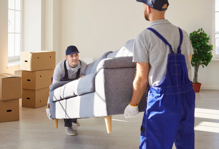 Delivery service arrange furniture transport, shipping specialists for transporting, men carrying, movers service unloading and removing things for moving company working, helping to change residenceの写真素材