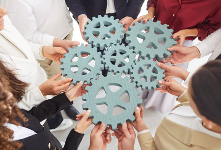 Gear, gearwheel machine parts close up of diverse colleagues holding assemble parts to find new business solution together, teambuilding activity, teamwork planning ideas, collaboration partnershipの写真素材