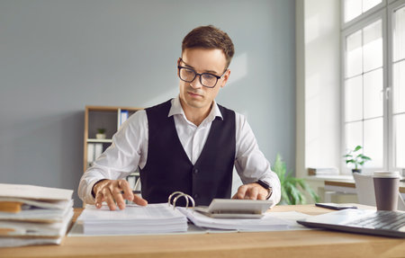 Financial management, businessman controlling and monitoring paper documents, resources. Male accountant handling company business goals, budget forecast, manage balance sheets and profit, lossの写真素材