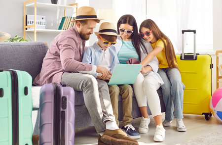 Planning family vacation at home, happy choosing trip online together, preparing for travel recreation. Parents, children dreaming of enjoyment, summer relaxation, leisure sea journey, reserving hotelの写真素材