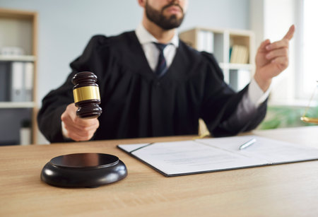 Gavel wooden hammer bangs, judge sentences in court of law, accuses guilty, proclamation, judgement, hitting on table to get attention, punctuate rulings, symbol of authority, final decision, trialの写真素材