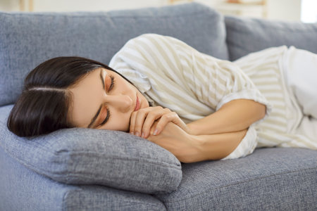 Woman sleeping, resting alone, lack of feeling, emotion, resting, enjoying rest during recovery, frustrated, having melancholic mood, need support to lonely sadの写真素材