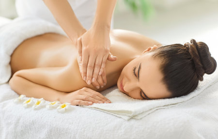 Professional shuolder massage treatment with aromatherapy, massage therapist doing oils massage, woman enjoying relaxing aromas spa, natural aromatics pleasure, soothing body and emotional balanceの写真素材
