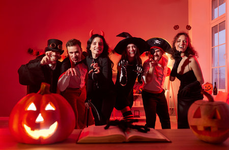 Portrait of a company of friends celebrates halloween together at a home party, dressed in costumes. fun, holiday excitement, and a joyful atmosphere, highlighting togetherness and festive spirit.の写真素材