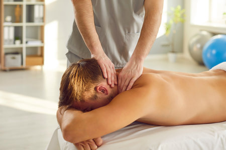 Neck massage, manual therapy rehabilitation, physical therapist doing manipulative therapy. Medical session to relieve tension, reduce headaches and increase relaxation, body health, sport, wellnessの写真素材