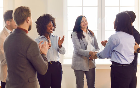 Business congratulating, welcoming new office employee, happy corporate team, group showing unity, human resources boss greets clients to express respect, agreement deal, new career opportunityの写真素材