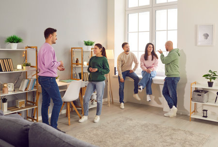 Company of friends or colleagues engages in communication during an event, celebration or party. People engage in conversations, discussing business, sharing laughter, and building connections.の写真素材