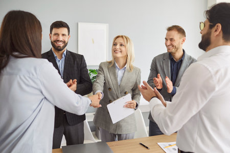 Business people shaking hands celebrating success, making a deal, business achievement or signing a...