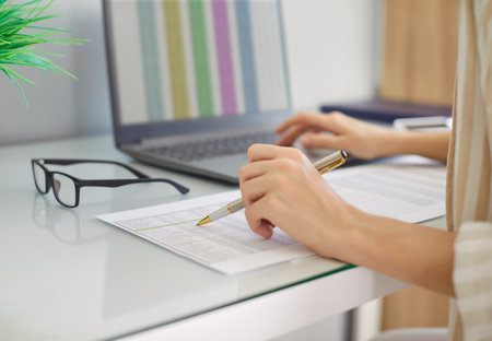 Woman recording, analysing stock market, female accountant calculator reporting financial transactions to calculate expenses, expenditures pay bills taxes online, managing home family, company budgetの写真素材