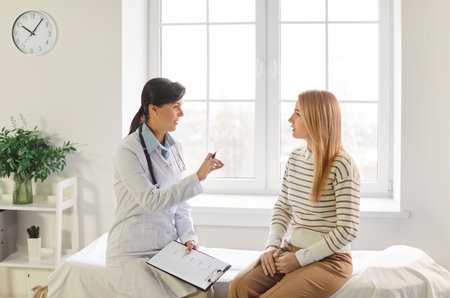 Feminist health clinic, supporting caring female doctor meeting, greeting, consulting young woman patient, offering medical advice in gynecology, sexual health, fertility, menopause, helpingの写真素材