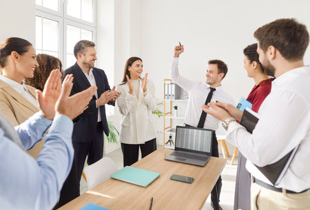 Happy office audience celebrating reward recognition, employer applauding on hr meeting, excited worker getting promotion, recognition, appreciate, respect, applause of colleagues introducing new planの写真素材