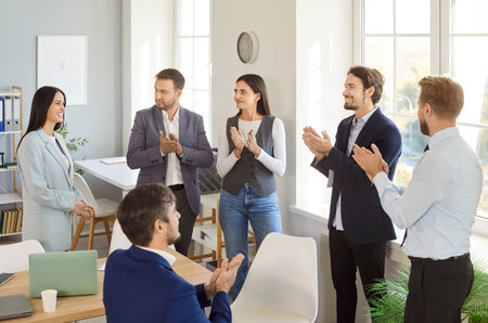Team of diverse and positive business people applauding to celebrating success during an office meeting. This event emphasizes teamwork, unity, and achievements in a collaborative environment.の写真素材