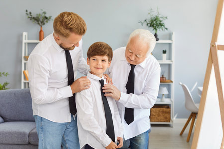 Father, son, and grandfather dress up together and look in the mirror at home on Father Day. They celebrate as a family, sharing this special moment with dad, bonding and enjoying the day together.の写真素材