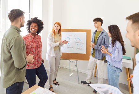 Group brainstorm, team employees planning report data with colleagues, presenting statistic graphs at whiteboard, mentor, coach, project leader speaking during office meeting, report presentationの写真素材