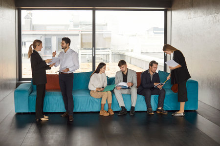 Business people working in an office, divided into teams. Engaged in conversations, negotiations, and teamwork during a professional meeting or conference, fostering collaboration and productivity.の写真素材