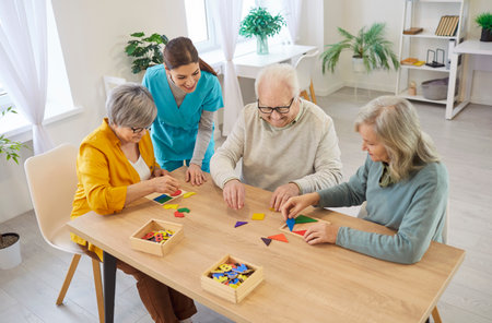 Senior people board game, tabletop playing, psychological treatment and doctor fun session, nurse care assistant in retirement home, old age nursing, older adults supportive community, geriatricianの写真素材