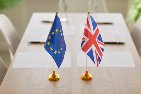 Negotiations between European Union and Great Britain in boardroom for conclusion of contracts with representatives of two countries. UK and EU flags on wooden table. Brexit and partnership concept.の写真素材